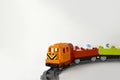 Plastic toy train with letters on railroad on white background. Royalty Free Stock Photo