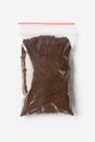 Plastic transparent zipper bag with full Brewed coffee powder isolated on white, Vacuum package mockup with red clip. Concept Royalty Free Stock Photo