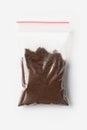 Plastic transparent zipper bag with half Brewed coffee powder isolated on white, Vacuum package mockup with red clip. Concept