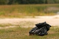 Black packet with garbage on countryside lake