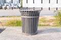 Plastic trash bin, dustbin black sphere shape road and green grass background. Royalty Free Stock Photo