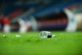 Plastic trash on the turf on a soccer field Royalty Free Stock Photo