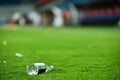 Plastic trash on the turf on a soccer field Royalty Free Stock Photo