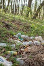 Plastic trash in the forest. Tucked nature. Plastic container lying in the grass Royalty Free Stock Photo