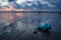 Plastic trash littering the ocean at the beach during sunset, Koh Lanta, Thailand