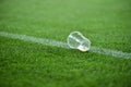 Plastic trash on the turf on a soccer field Royalty Free Stock Photo