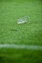 Plastic trash on the turf on a soccer field Royalty Free Stock Photo
