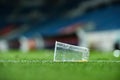 Plastic trash on the turf on a soccer field Royalty Free Stock Photo