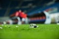 Plastic trash on the turf on a soccer field Royalty Free Stock Photo