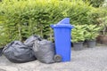 Plastic trashcan, overloaded with wastes and rubbish