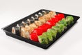 Plastic tray with set of rolls with smoked salmon, eel, chukka salad and flying fish roe Royalty Free Stock Photo