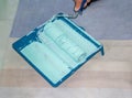 Plastic tray with paint and soft roller in gren paint. Tools for the painter and redecoration on the carpet. Interior renovation Royalty Free Stock Photo