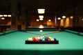 Plastic triangle rack with billiard balls and cues on green table indoors Royalty Free Stock Photo