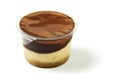 Plastic tub with tasty cream and chocolate dessert on white background