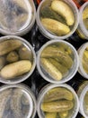 Plastic tubs of pickles top view looking down grocery store shelf
