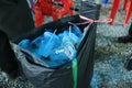 Plastic tumblers were discarded in many black trash bags.