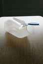 Plastic urinal on a table Royalty Free Stock Photo