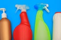 Plastic washing containers on a blue background for the cleaning the kitchen, bathroom. Detergents, bottles, various sizes and
