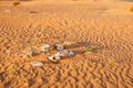 Plastic waste, bags packaging and other rubbish trash abandoned in a pristine sand desert environment biodegrading under a harsh