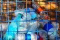 Plastic waste behind the metal bars Royalty Free Stock Photo