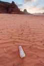 Plastic waste bottle on sand in desert. Environmental problem, plastic waste problems, and global warming
