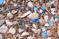 Plastic waste rubbish and garbage on pebble seashore after storm, closeup view. Royalty Free Stock Photo