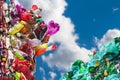 Plastic waste from used crumpled PET bottles in colored bales on blue sky background with white cloud Royalty Free Stock Photo