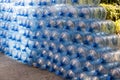 Plastic water bottle background, blue bottle caps, orderly arrangement. Empty bottles for drinking water. Heap of empty plastic dr Royalty Free Stock Photo