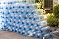 Plastic water bottle background, blue bottle caps, orderly arrangement. Empty bottles for drinking water. Heap of empty plastic dr