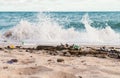 Plastic water bottle being dumped on the beach Royalty Free Stock Photo