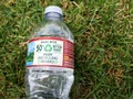 Plastic water bottle close up on green grass nature environment concept