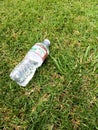 Plastic water bottle close up on green grass nature environment concept