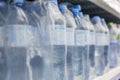 Plastic water bottles in packaging on a shelf in a store. Blurred. Side view Royalty Free Stock Photo