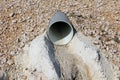 Plastic water pipe drain surrounded with gravel and concrete Royalty Free Stock Photo