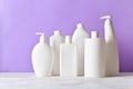 Plastic white bottles on a light purple background. Layout of bottles with household chemicals for cleaning and Royalty Free Stock Photo