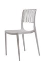 Plastic white chair with a wicker back. Patio or cafe furniture. Royalty Free Stock Photo