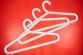 Plastic white coat hangers clothes hanger on red background