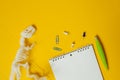 Plastic white dinosaur skeleton, Notepad, paper clips and pen. Set for studying and describing excavations of dinosaurs and