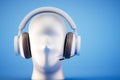 Plastic white mannequin head with musical stereo headphones, closeup on a blue background. 3d render