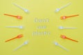 Plastic forks on yellow background