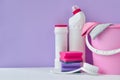 White bottles of household chemicals on a purple background with a copy of space Royalty Free Stock Photo