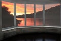Plastic window overlooking beautiful crimson sunset above river