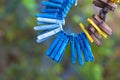 Plastic, wood, old clothes pegs hanging on a rope Royalty Free Stock Photo