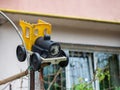 Plastic yellow black old toy car tied to metal bars on a blurred background Royalty Free Stock Photo