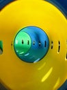 Yellow, blue and green tunnel tube slide at playground