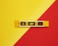 Plastic yellow level tool with capsules on red background Royalty Free Stock Photo
