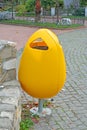 Yellow  plastic garbage can in the park Royalty Free Stock Photo