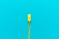 Plastic yellow whistle on turquoise blue background Royalty Free Stock Photo