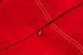 Plastic zipper in a product made of red linen fabric