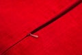 Plastic zipper in a product made of red linen fabric